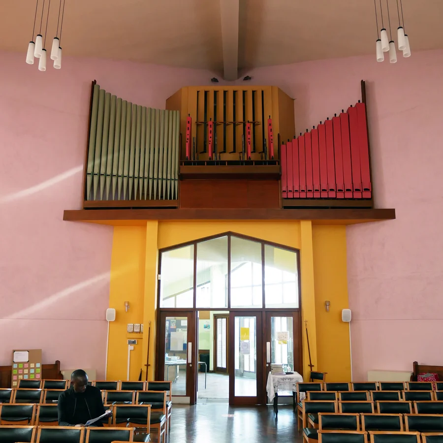 Interior shot of organ above pews in modern church